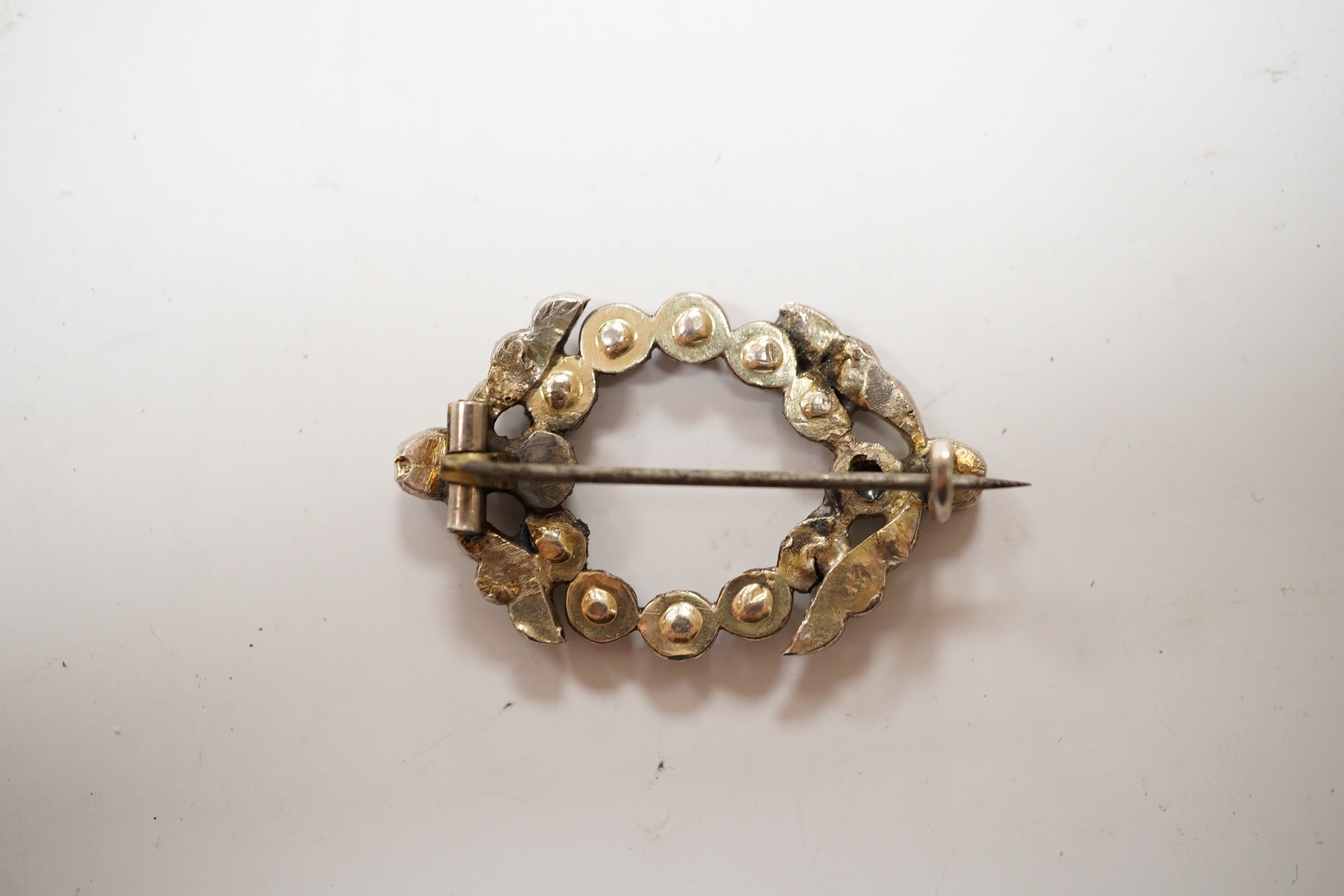 An antique white metal and rose cut diamond set open work brooch, 34mm, gross weight 5.5 grams. Condition - poor to fair